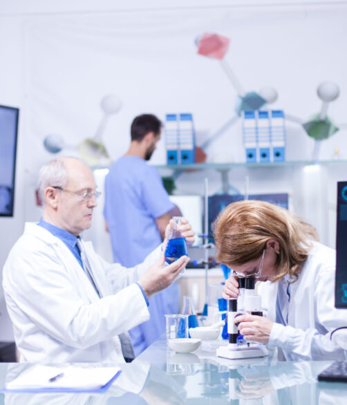 Groupe of researchers in pharmacology in a hospital laboratory. Modern equipment in research laboratory.